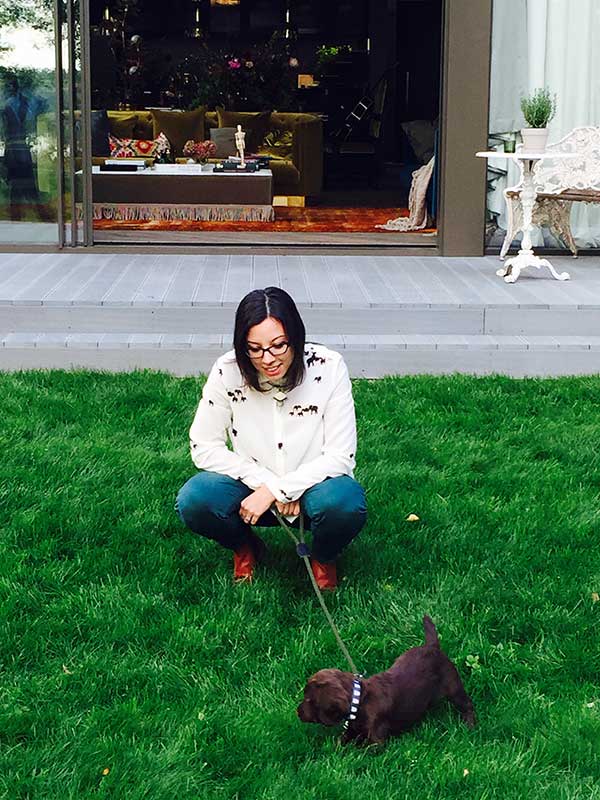 Sharday Awori with her dog in the garden